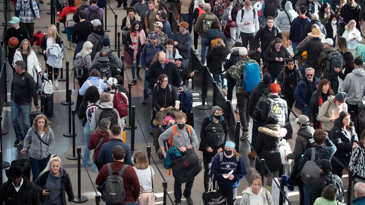 Travellers queue up to pass security at Denver International Airport.