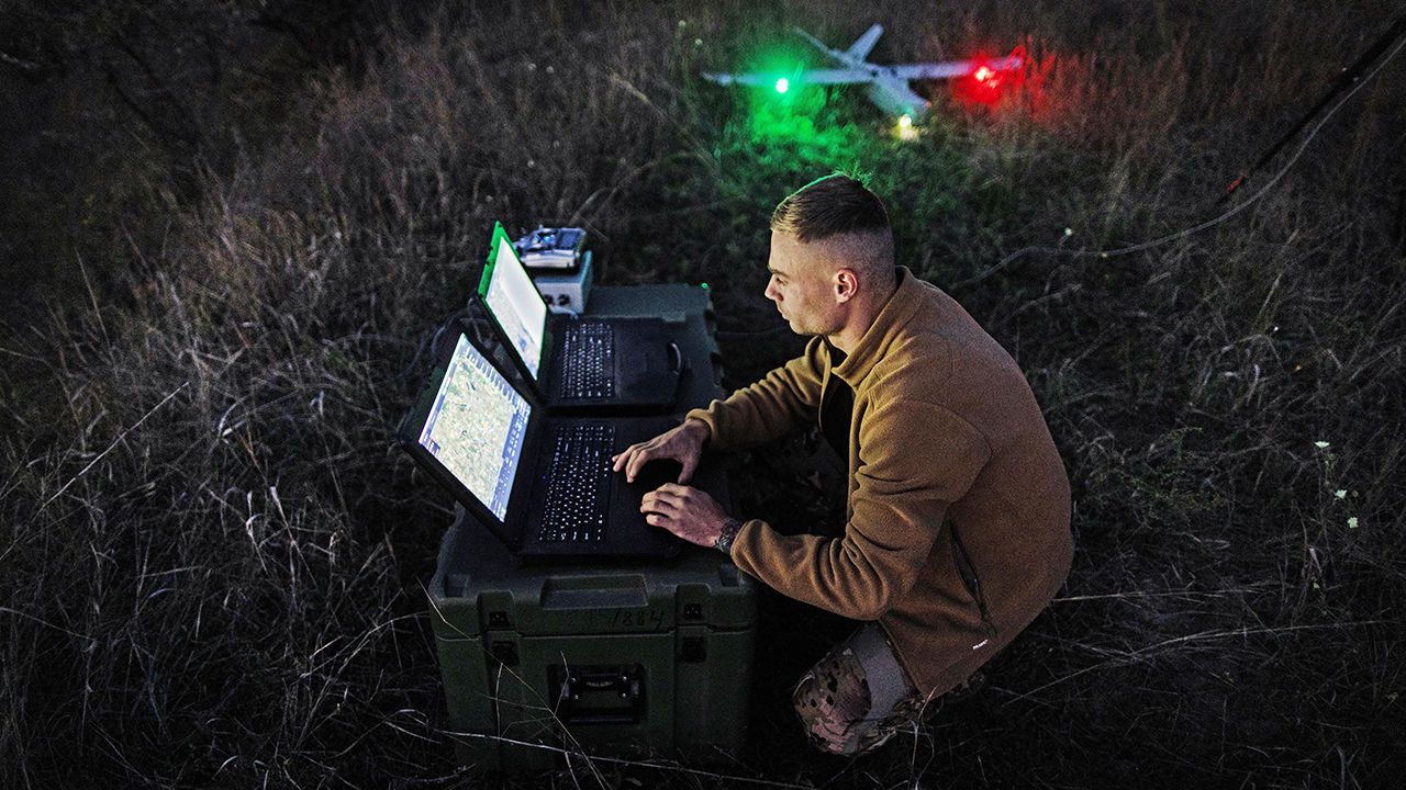 A Ukrainian soldier controls a drone before an exercise