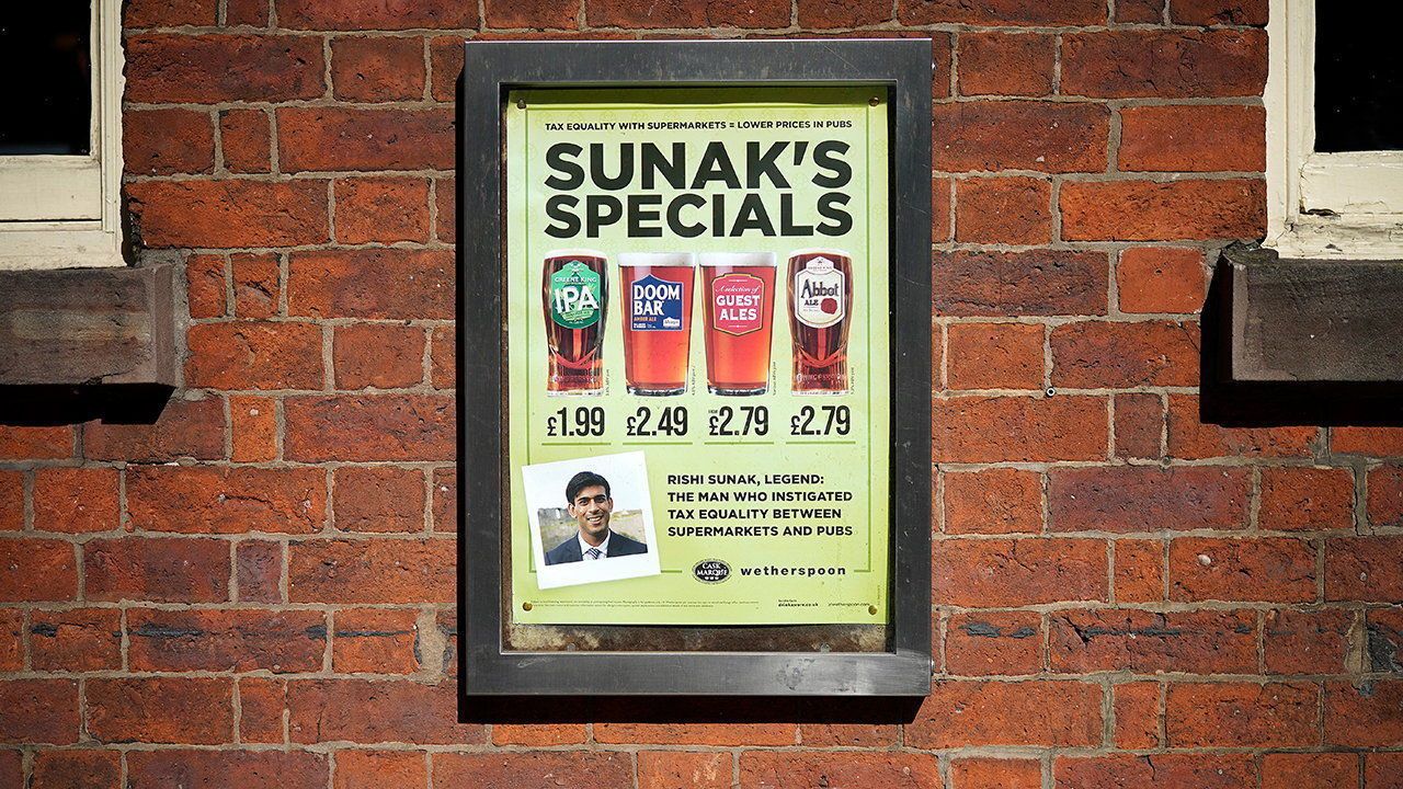 A poster on the wall of a Wetherspoon pub advertises 'Sunak's Specials' drinks.