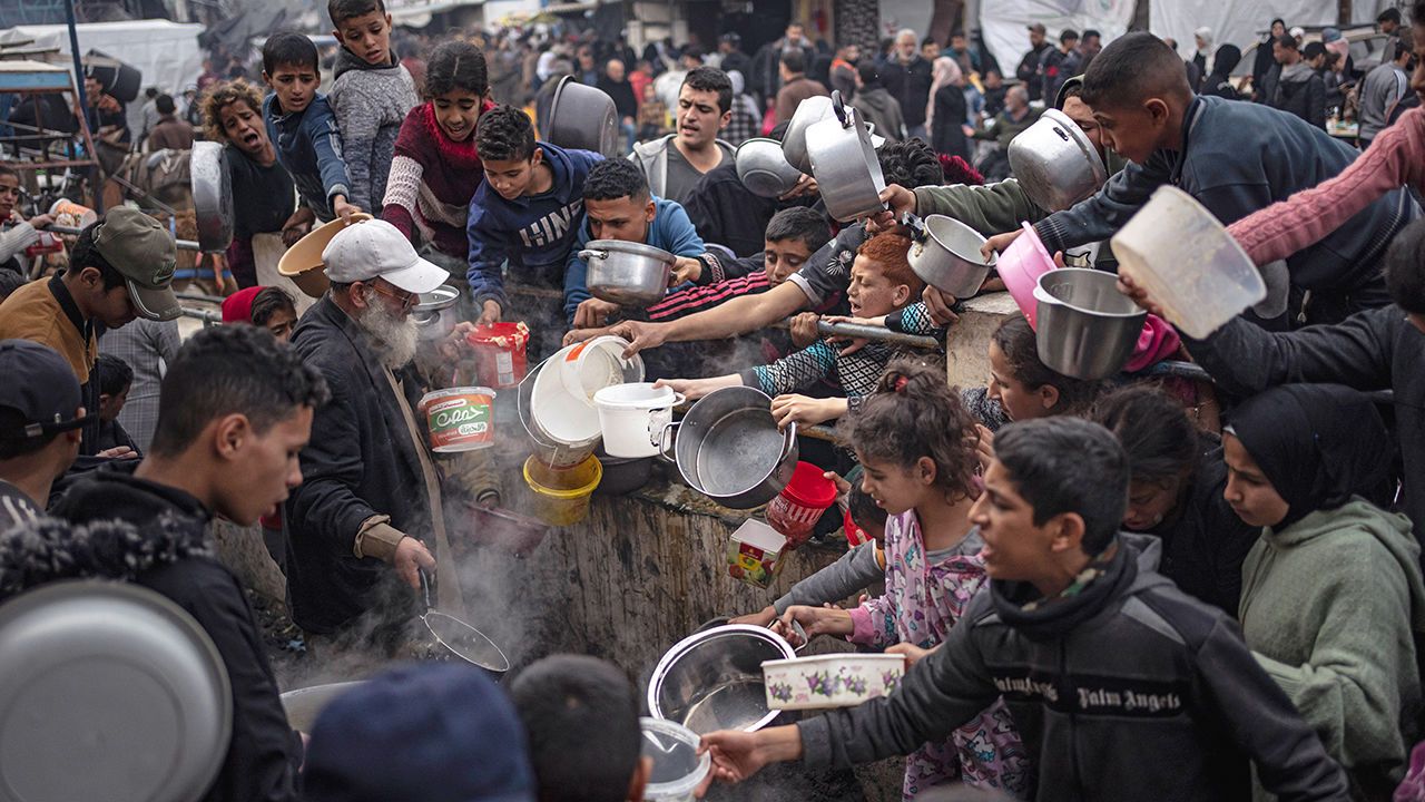 FILE - Palestinians line up for a meal in Rafah, Gaza Strip, Thursday, Dec. 21, 2023. The United Nations said Tuesday, M