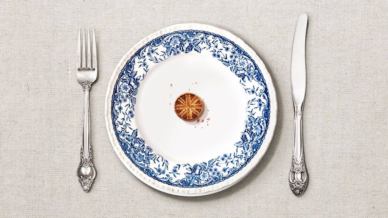 A british plate with a tiny pie in the middle, stamped with the Union Jack sign.