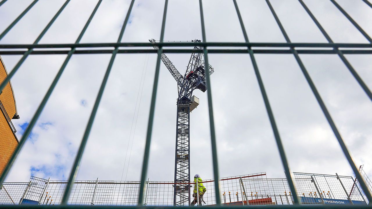 A builder works on a construction site in Reading, Britain.