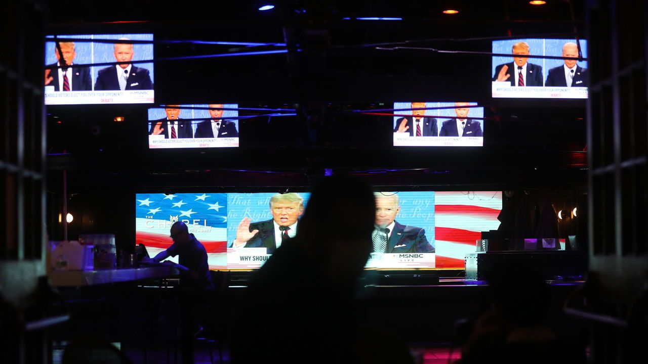 A broadcast of the first debate in 2020 between President Donald Trump and Democratic presidential nominee Joe Biden is played on indoor televisions. 