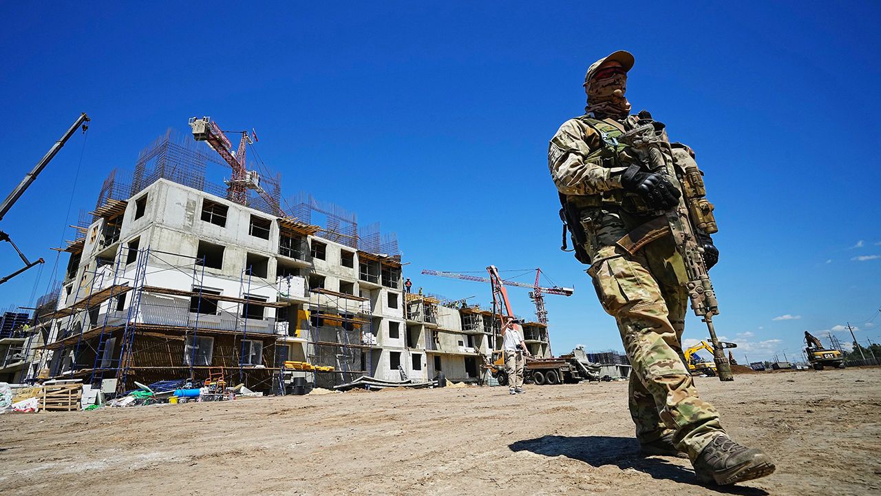 A Russian soldier guards the site of a new apartment building in Mariupol, Ukraine