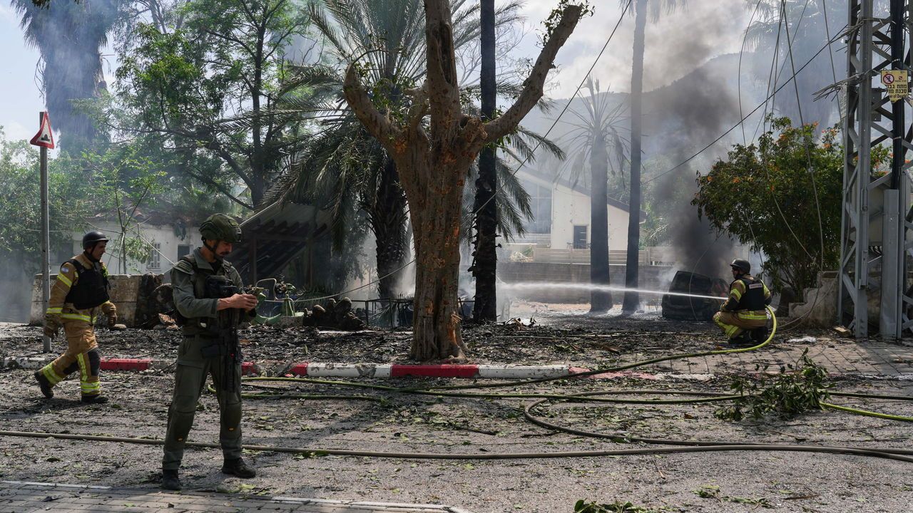 Israeli security forces at the scene where a rocket fired from Lebanon into Northern Israel hit the northern Israeli city of Kiryat Shmona