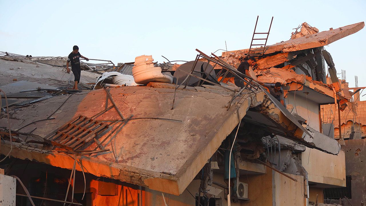 People inspect a building destroyed in an Israeli airstrike in Al-Maghazi refugee camp, central Gaza Strip, on July 15th 2024