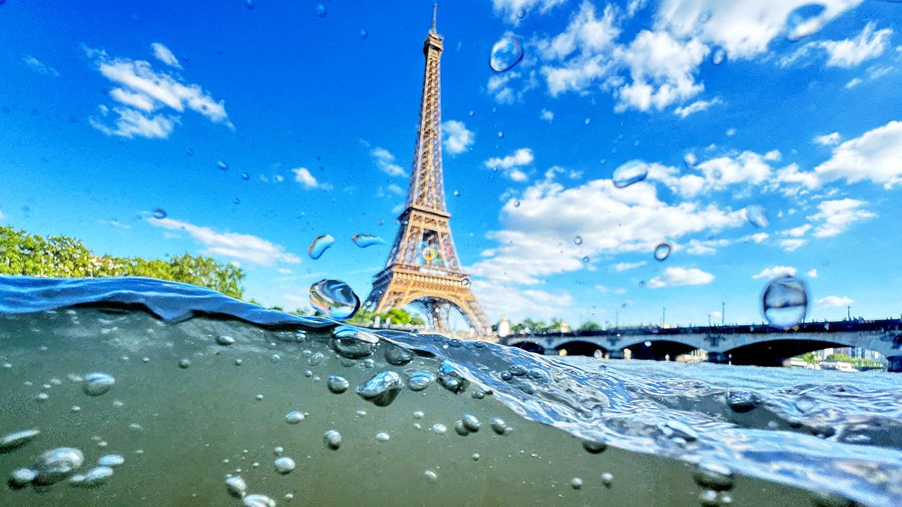 The Eiffel Tower is seen from the water of the Seine River 