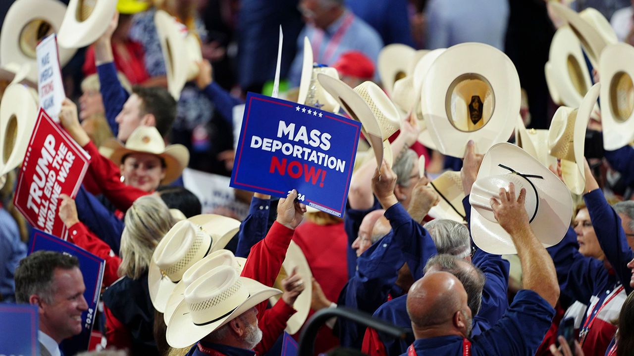 An attendee holds a sign reading "Mass Deportations Now!" at the Republican National Convention in Milwaukee, on July 17th 2024