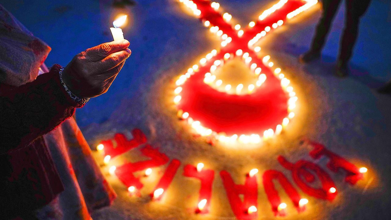  Candles around a red ribbon for World AIDS day. 