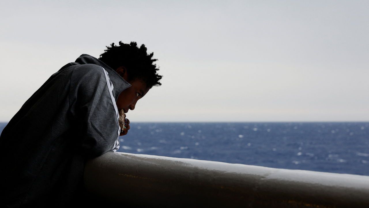 A migrant looks at the sear from a rescue ship in the Mediterranean sea